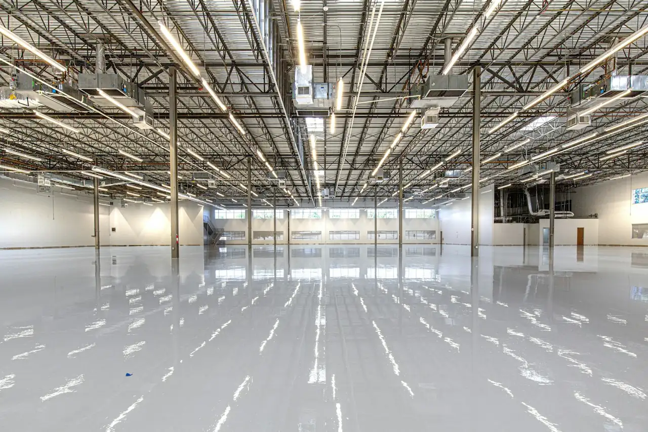 Glossy epoxy floor coating reflecting rows of overhead lights